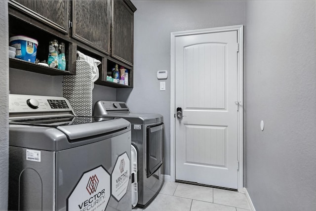 18819 Deer Trace Dr, Crosby, TX 77532 - laundry area with cabinet space, washing machine and dryer, and light tile patterned flooring