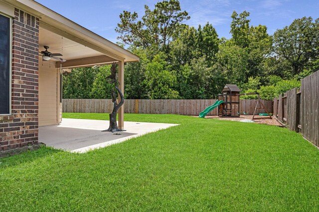 18819 Deer Trace Dr, Crosby, TX 77532 - fenced backyard featuring a ceiling fan, a patio area, and a playground