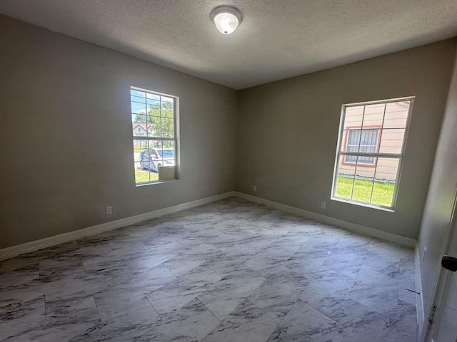7410 Dallas St, Houston, TX 77011 - empty room featuring healthy amount of natural light and a textured ceiling