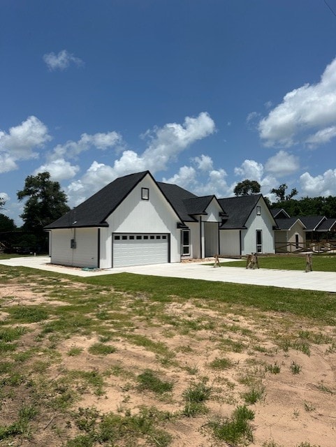 24630 Cavan St, Hempstead, TX 77445 - view of front facade with driveway, a garage, and a front lawn