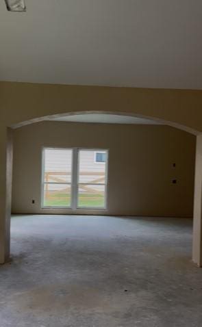 24630 Cavan St, Hempstead, TX 77445 - carpeted empty room with arched walkways and vaulted ceiling