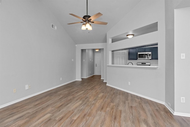 2307 Pine Cone Dr, Houston, TX 77339 - unfurnished living room with wood finished floors, ceiling fan, and high vaulted ceiling