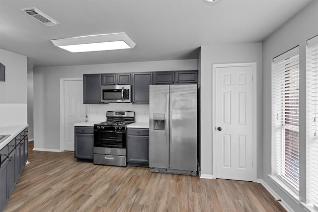 2307 Pine Cone Dr, Houston, TX 77339 - kitchen with stainless steel appliances, healthy amount of natural light, light wood-style flooring, and light countertops