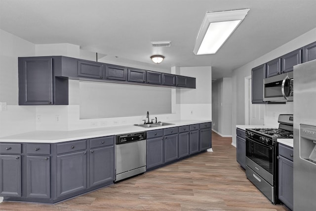 2307 Pine Cone Dr, Houston, TX 77339 - kitchen featuring stainless steel appliances, light wood-type flooring, and light countertops