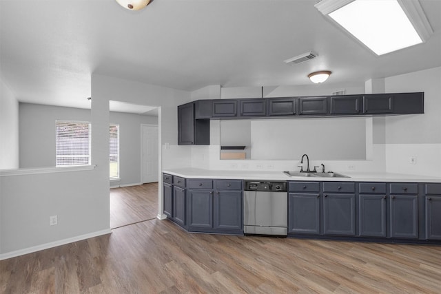 2307 Pine Cone Dr, Houston, TX 77339 - kitchen with dishwasher, light wood-style flooring, and light countertops