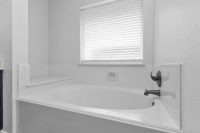 2307 Pine Cone Dr, Houston, TX 77339 - full bath with a garden tub and a textured wall