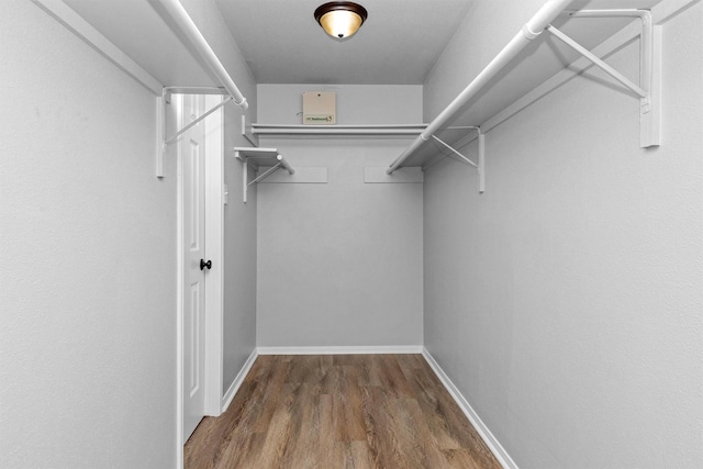 2307 Pine Cone Dr, Houston, TX 77339 - walk in closet featuring wood finished floors