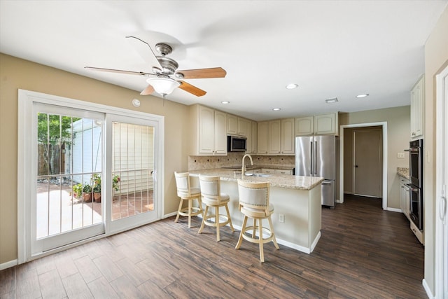 3002 Durban Dr, Houston, TX 77043 - kitchen featuring stainless steel appliances, a peninsula, dark wood finished floors, tasteful backsplash, and ceiling fan