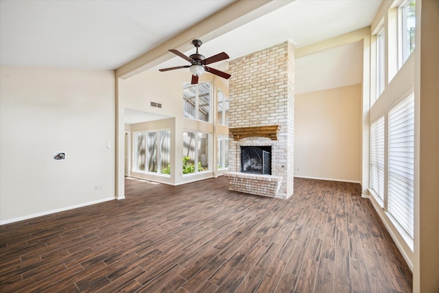 3002 Durban Dr, Houston, TX 77043 - unfurnished living room featuring ceiling fan, beamed ceiling, healthy amount of natural light, high vaulted ceiling, and a brick fireplace