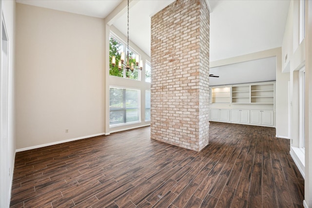 3002 Durban Dr, Houston, TX 77043 - unfurnished living room with high vaulted ceiling, dark wood-style flooring, and a chandelier