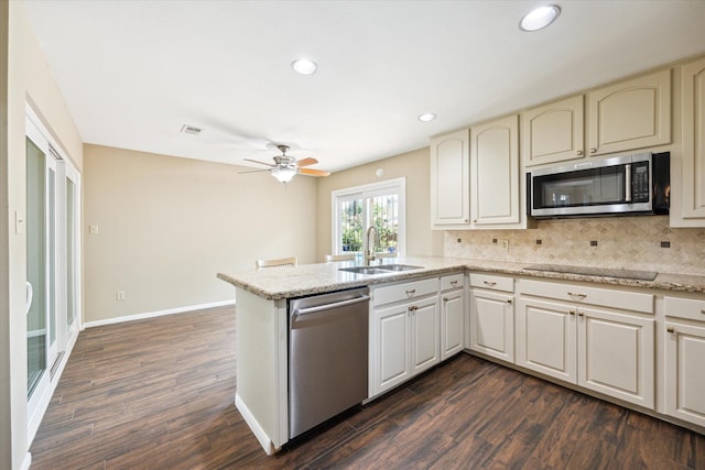 3002 Durban Dr, Houston, TX 77043 - kitchen with stainless steel appliances, a peninsula, dark wood-type flooring, tasteful backsplash, and recessed lighting