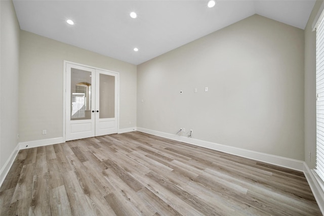 23414 Fauburg Dr, New Caney, TX 77357 - spare room with french doors, recessed lighting, wood finished floors, and lofted ceiling