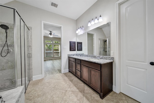 23414 Fauburg Dr, New Caney, TX 77357 - bathroom featuring a shower stall, double vanity, a ceiling fan, and tile patterned floors