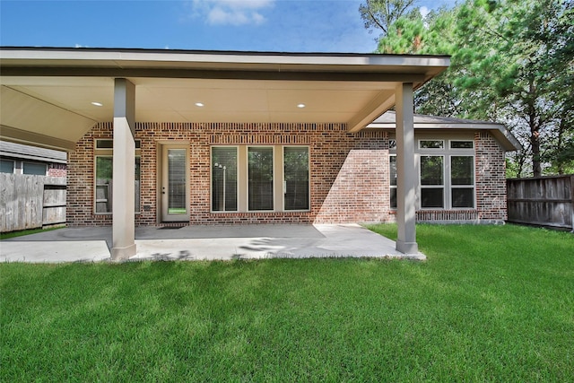 23414 Fauburg Dr, New Caney, TX 77357 - rear view of property with brick siding and a patio