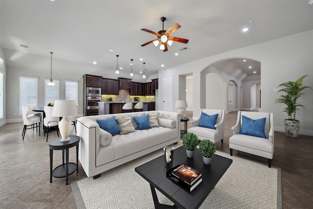 23414 Fauburg Dr, New Caney, TX 77357 - living room with a ceiling fan, recessed lighting, and arched walkways