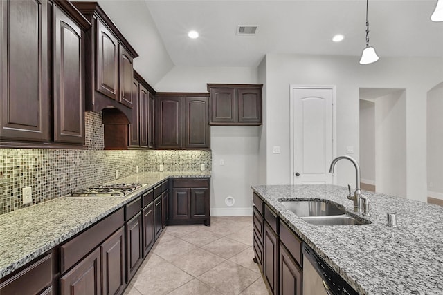 23414 Fauburg Dr, New Caney, TX 77357 - kitchen with stainless steel appliances, backsplash, light stone countertops, hanging light fixtures, and light tile patterned floors