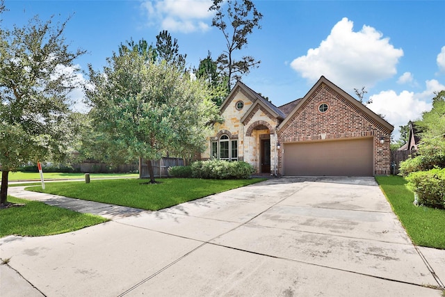 23414 Fauburg Dr, New Caney, TX 77357 - view of front of house with a garage, concrete driveway, stone siding, and brick siding