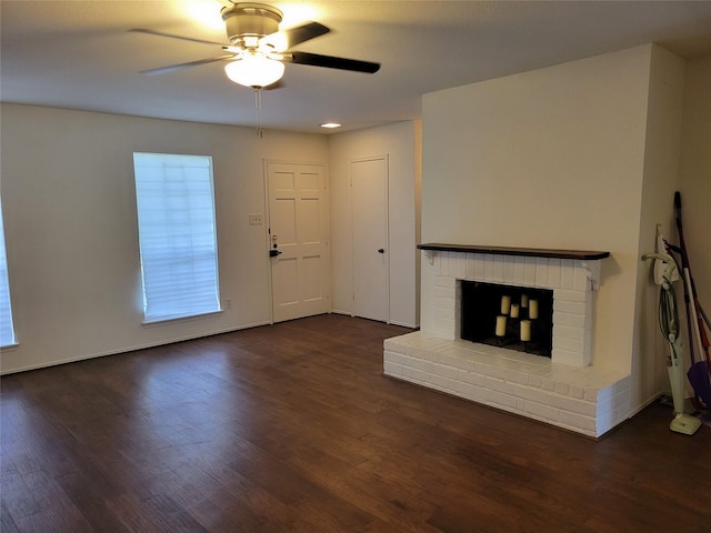 5801 Lumberdale Rd Unit 226, Houston, TX 77092 - unfurnished living room featuring a ceiling fan, a brick fireplace, and dark wood-style flooring