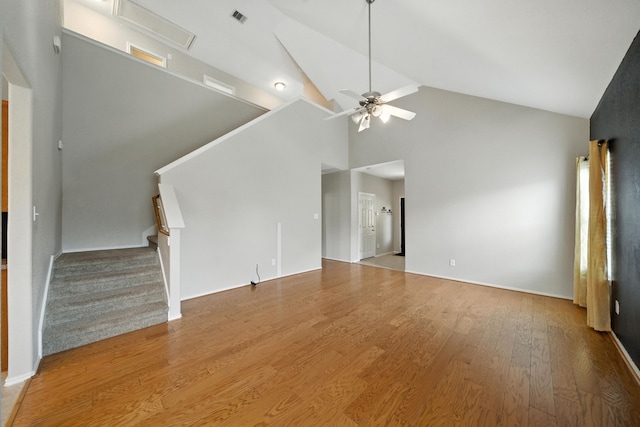 18123 Hillock Glen Ln, Cypress, TX 77429 - unfurnished living room featuring stairway, high vaulted ceiling, wood finished floors, and a ceiling fan