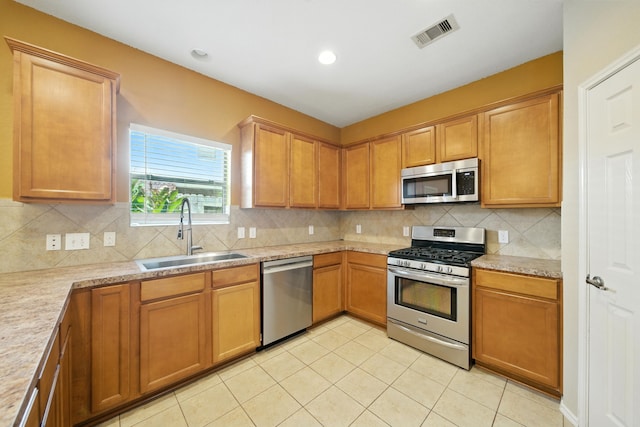 18123 Hillock Glen Ln, Cypress, TX 77429 - kitchen featuring stainless steel appliances, light countertops, decorative backsplash, light tile patterned flooring, and recessed lighting