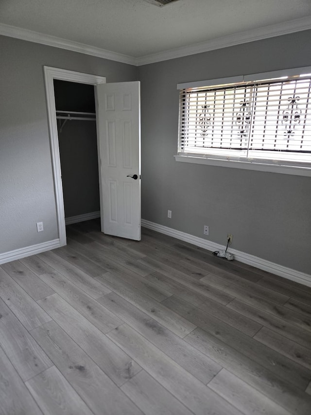 6814 Della St, Houston, TX 77093 - unfurnished bedroom featuring crown molding, wood finished floors, and a closet