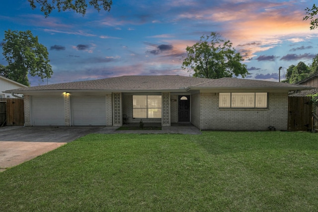 6814 Della St, Houston, TX 77093 - ranch-style house featuring an attached garage, concrete driveway, and brick siding