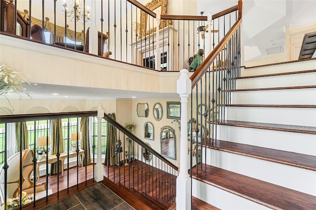 1734 Forestlake Dr, Sugar Land, TX 77479 - staircase featuring a towering ceiling and wood finished floors