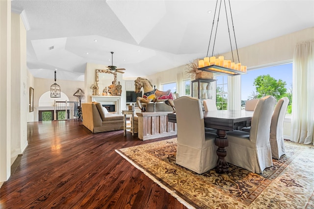 1734 Forestlake Dr, Sugar Land, TX 77479 - dining room featuring dark wood-style flooring, a glass covered fireplace, a chandelier, recessed lighting, and lofted ceiling