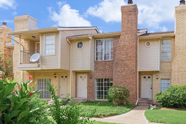 3600 Jeanetta St Unit 1902, Houston, TX 77063 - view of property featuring brick siding, a chimney, and a balcony