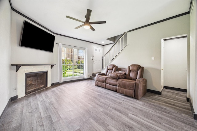 3600 Jeanetta St Unit 1902, Houston, TX 77063 - living room featuring a ceiling fan, wood finished floors, a fireplace, ornamental molding, and stairway