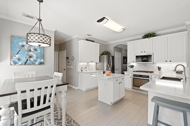 16403 Bogan Flats Ct, Houston, TX 77095 - kitchen with stainless steel appliances, arched walkways, backsplash, light countertops, and crown molding