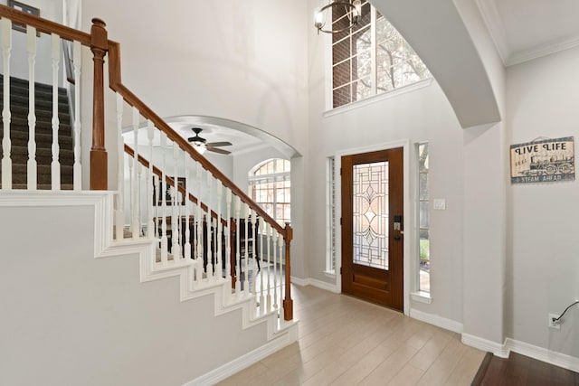 16403 Bogan Flats Ct, Houston, TX 77095 - entrance foyer featuring stairs, light wood-type flooring, crown molding, a ceiling fan, and a high ceiling