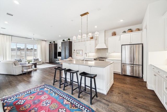 928 Robbie St Unit B, Houston, TX 77009 - kitchen featuring stainless steel refrigerator, open floor plan, custom range hood, a breakfast bar, and dark wood-style floors