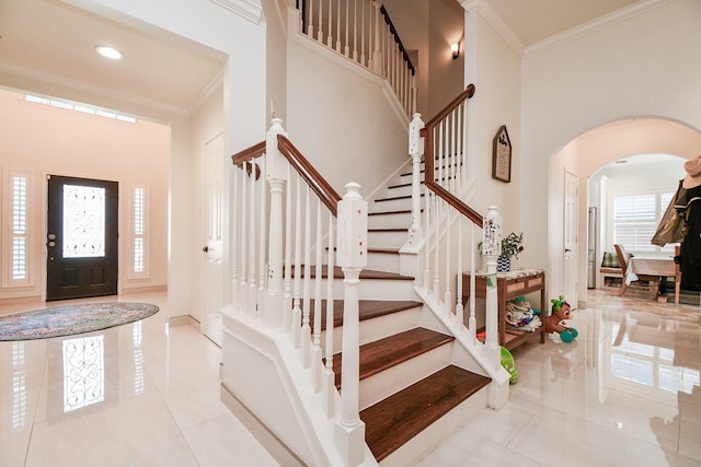 9302 Stone Porch Ln, Houston, TX 77064 - tiled foyer featuring arched walkways, ornamental molding, a high ceiling, and stairway