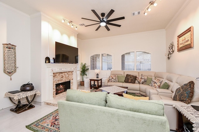 9302 Stone Porch Ln, Houston, TX 77064 - living area with track lighting, ceiling fan, ornamental molding, a tiled fireplace, and tile patterned floors