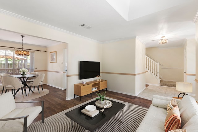 34 Sweetdream Pl, The Woodlands, TX 77381 - living area featuring a chandelier, wood finished floors, crown molding, and stairs