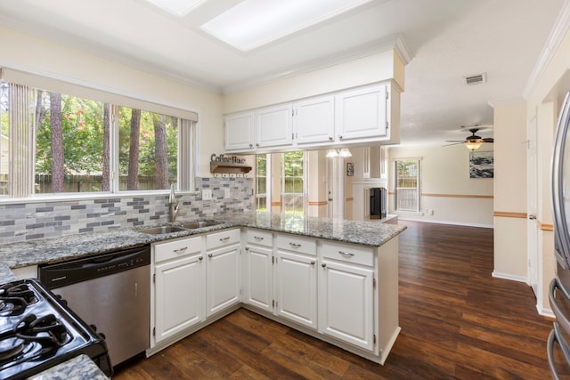 34 Sweetdream Pl, The Woodlands, TX 77381 - kitchen with dishwasher, a peninsula, ornamental molding, backsplash, and light stone countertops