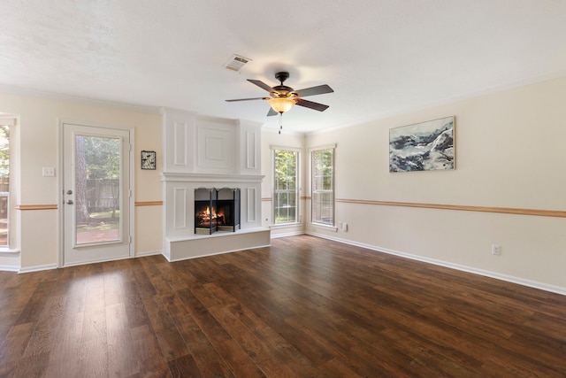 34 Sweetdream Pl, The Woodlands, TX 77381 - unfurnished living room featuring wood-type flooring, healthy amount of natural light, a ceiling fan, a large fireplace, and crown molding