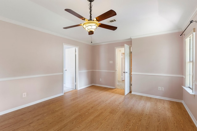 34 Sweetdream Pl, The Woodlands, TX 77381 - unfurnished room with light wood-style floors, a ceiling fan, and crown molding