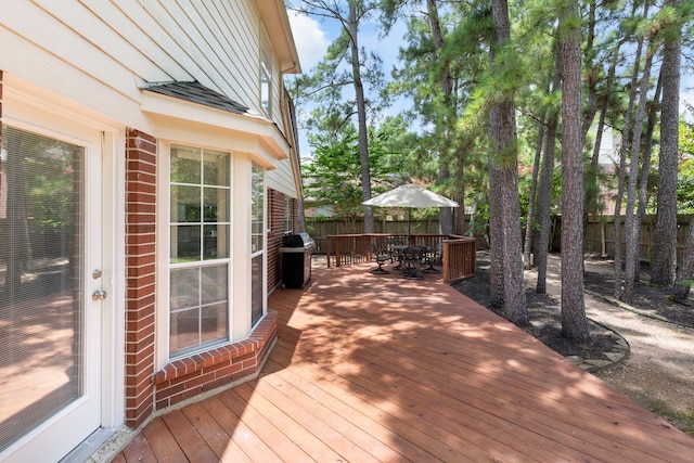 34 Sweetdream Pl, The Woodlands, TX 77381 - wooden terrace featuring grilling area, a fenced backyard, and outdoor dining space