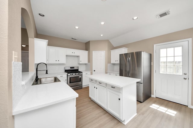 7407 Rustic Chase Dr, Richmond, TX 77407 - kitchen featuring stainless steel appliances, light wood-style flooring, backsplash, a kitchen island, and recessed lighting