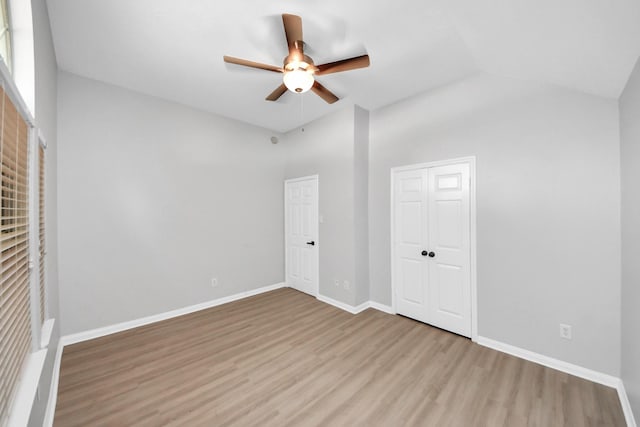 7407 Rustic Chase Dr, Richmond, TX 77407 - unfurnished bedroom with wood finished floors, a closet, a ceiling fan, and lofted ceiling