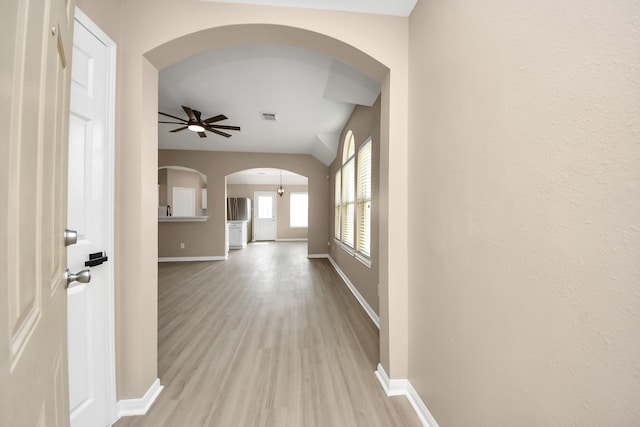 7407 Rustic Chase Dr, Richmond, TX 77407 - corridor featuring arched walkways and light wood finished floors