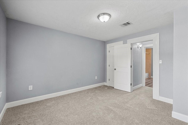 3217 Michigan St, Baytown, TX 77520 - unfurnished bedroom with carpet floors and a textured ceiling