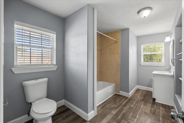 3217 Michigan St, Baytown, TX 77520 - full bathroom with vanity, wood finished floors, shower / tub combination, and a textured ceiling