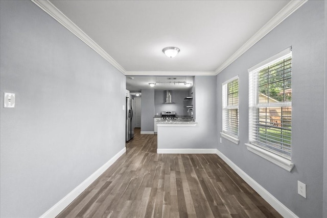 3217 Michigan St, Baytown, TX 77520 - unfurnished dining area with crown molding and dark wood-style flooring