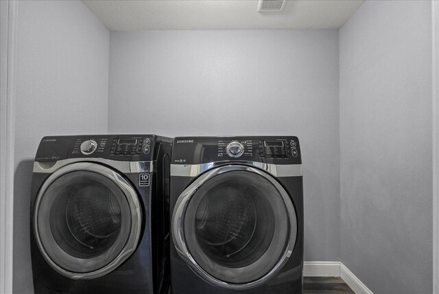 3217 Michigan St, Baytown, TX 77520 - laundry area featuring washer and clothes dryer and wood finished floors