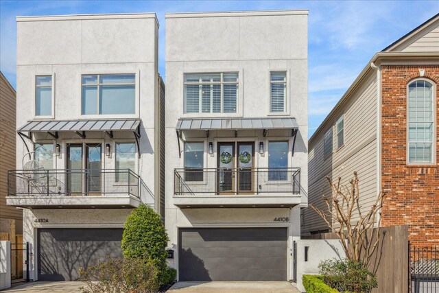 4410 Floyd St Unit B, Houston, TX 77007 - view of property with stucco siding, a standing seam roof, a balcony, and a garage