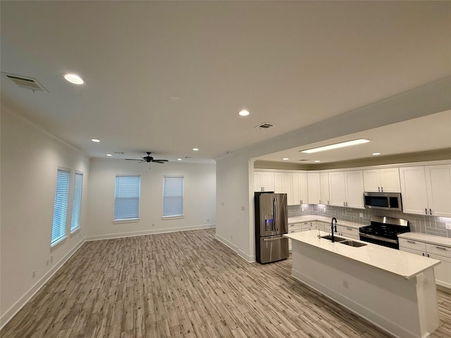 6635 Tc Jester Blvd Unit A, Houston, TX 77007 - kitchen featuring stainless steel appliances, decorative backsplash, white cabinetry, light wood finished floors, and recessed lighting