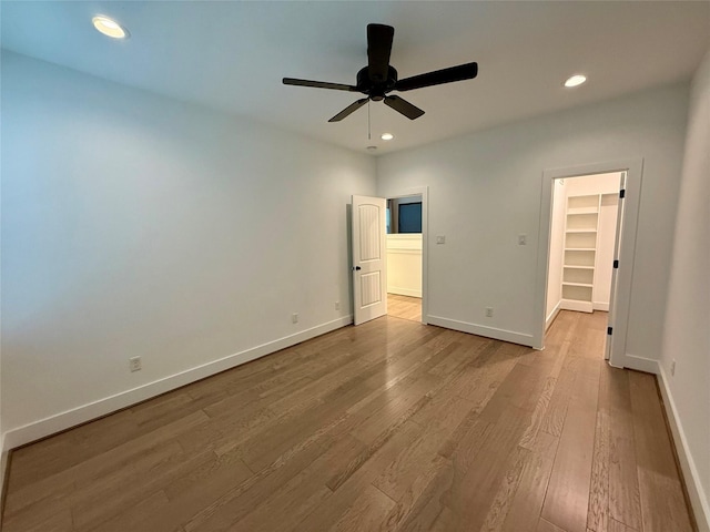 6635 Tc Jester Blvd Unit A, Houston, TX 77007 - unfurnished bedroom with wood finished floors, a walk in closet, recessed lighting, a ceiling fan, and a closet